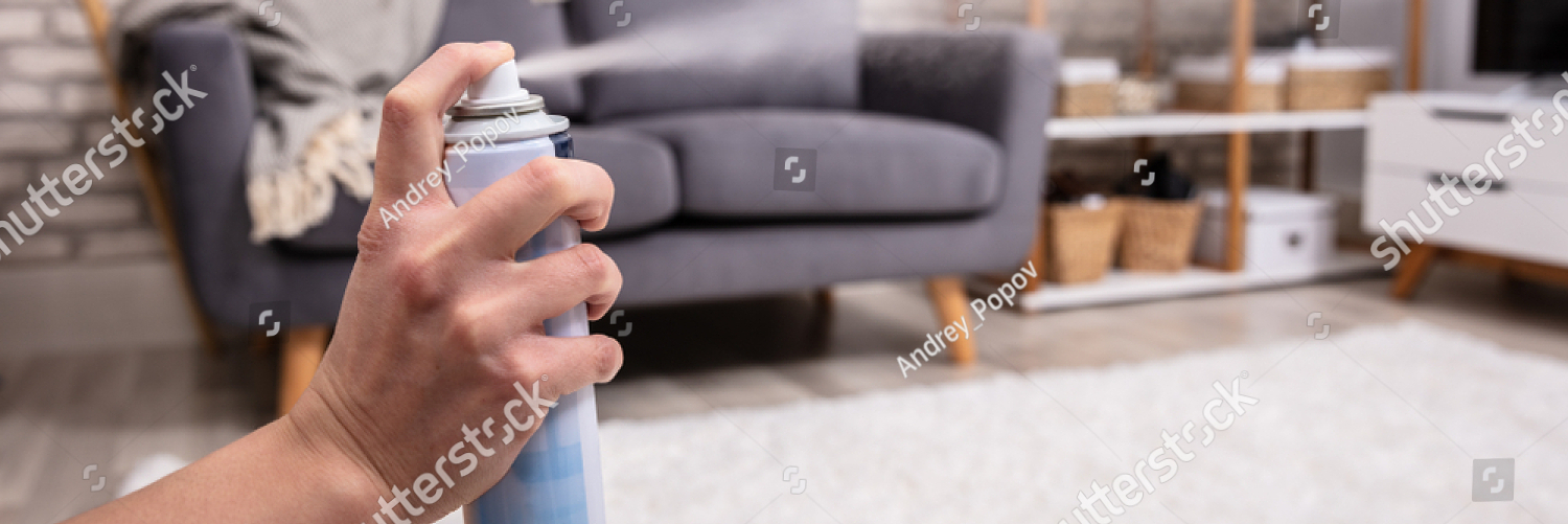 stock photo close up of a human s hand spraying air freshener in living room 1361083250