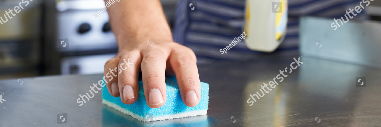 stock photo close up of worker in restaurant kitchen cleaning down after service 676151164