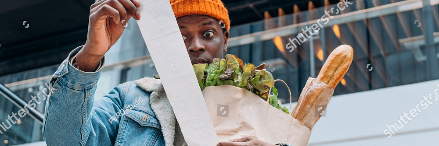 stock photo doubting african american person in denim jacket looks at sales paper receipt total holding pack 2017774268