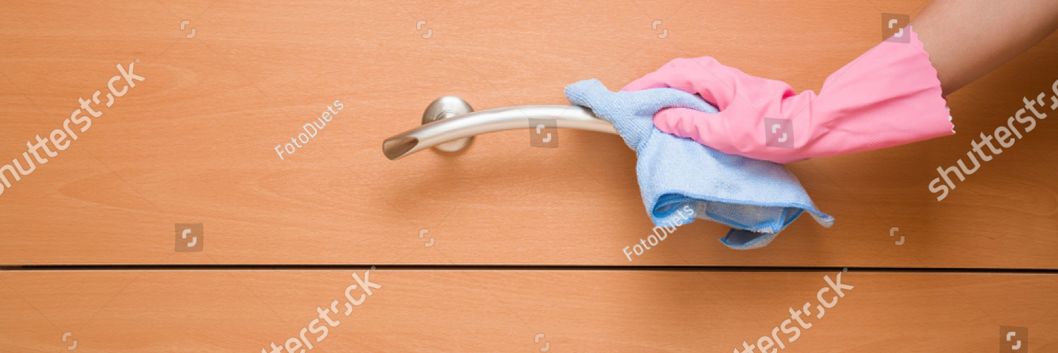 stock photo employee hand in rubber protective glove wiping wooden chest of drawers and metal handle with rag 1121850311