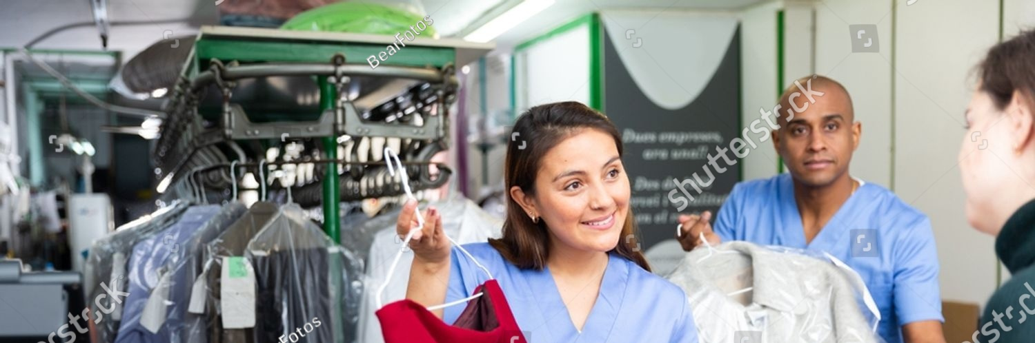 stock photo ordinary woman and man working with client in modern laundry receiving clothing for dry cleaning 2303526449