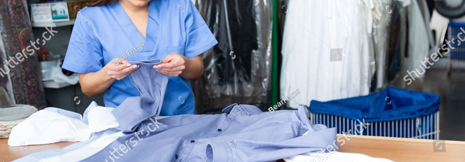 stock photo portrait of skilled female laundry worker examining clean garments 2377370891