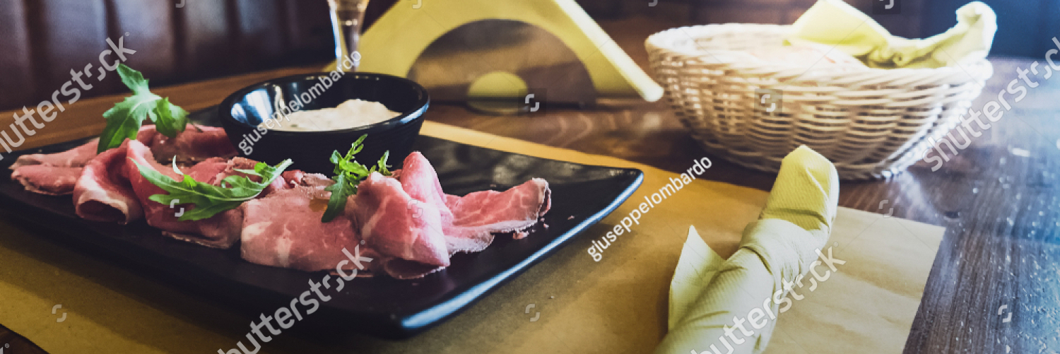 stock photo salami and rocket salad in an italian restaurant served with a cold beer on a wooden table with 1168266040