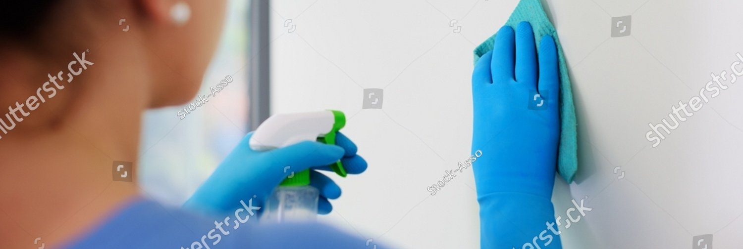 stock photo woman holding a detergent and cleaning walls at home 2176052655