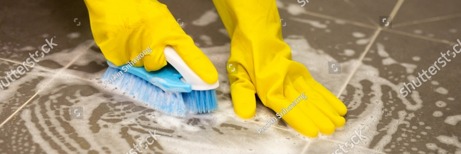 stock photo woman s hand washing the tile floor with a brush while donning yellow rubber gloves housewife 2199851217