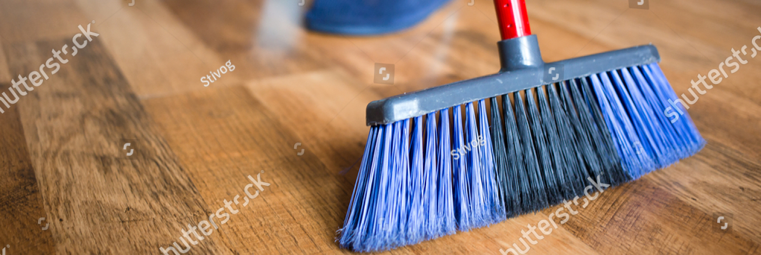 stock photo young woman wife in blue slippers using indoor blue broom for hardwood floor cleaning spring 1648078099